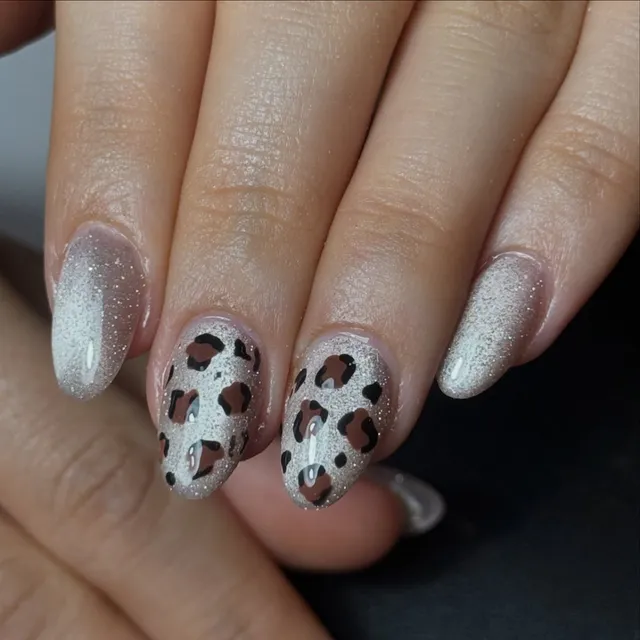 Silver glitter and leopard-print nail art
