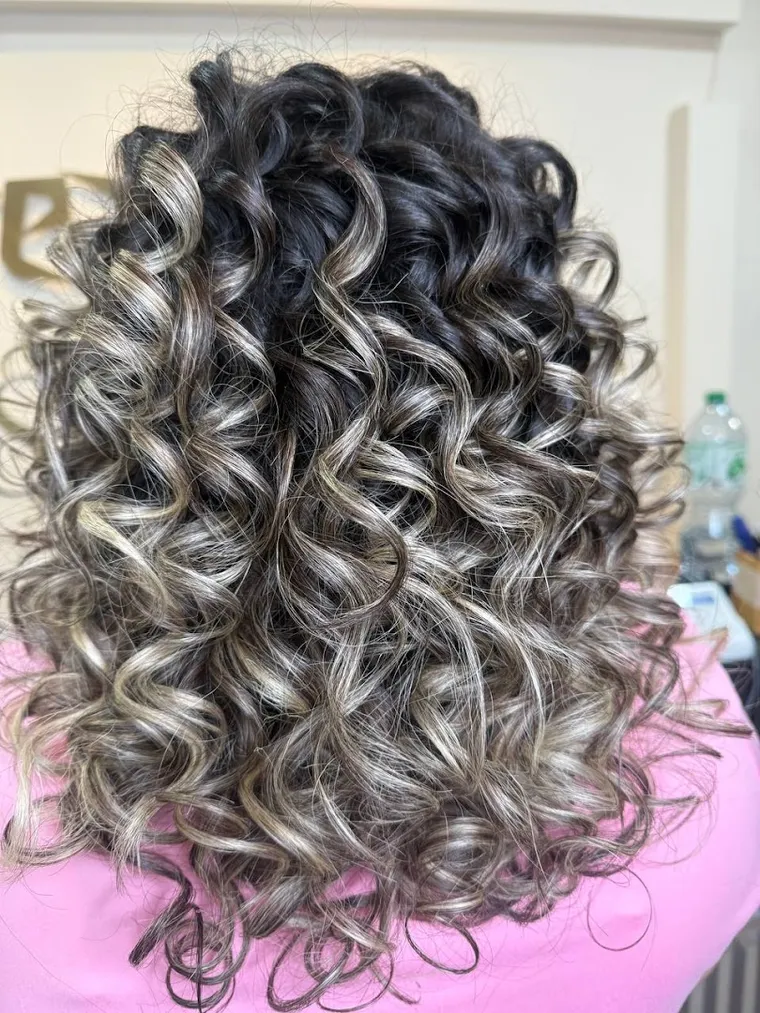 A silver-blonde head of curls, coloured and styled at Dream Cutz